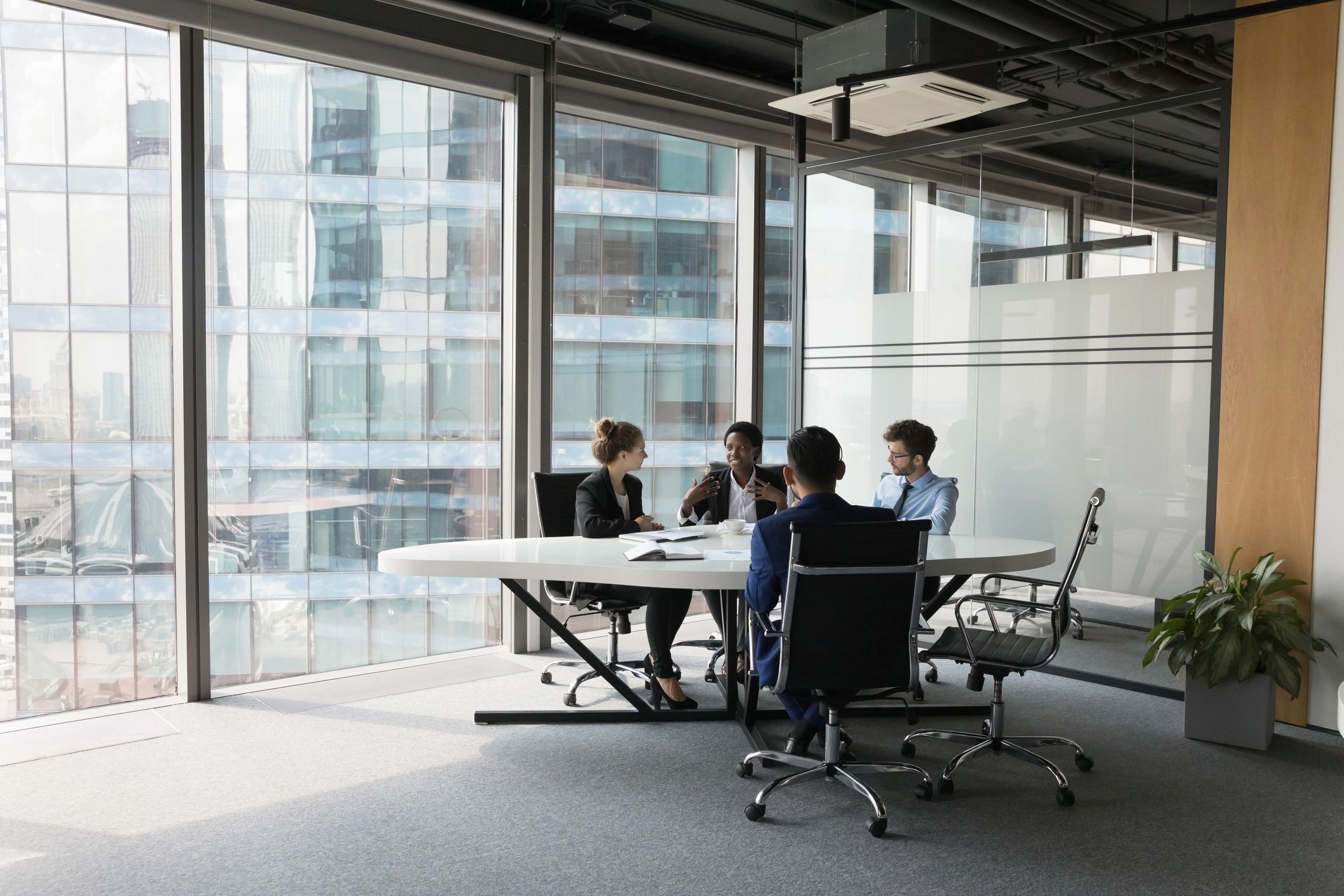 Diverse millennial business team talking in a meeting room