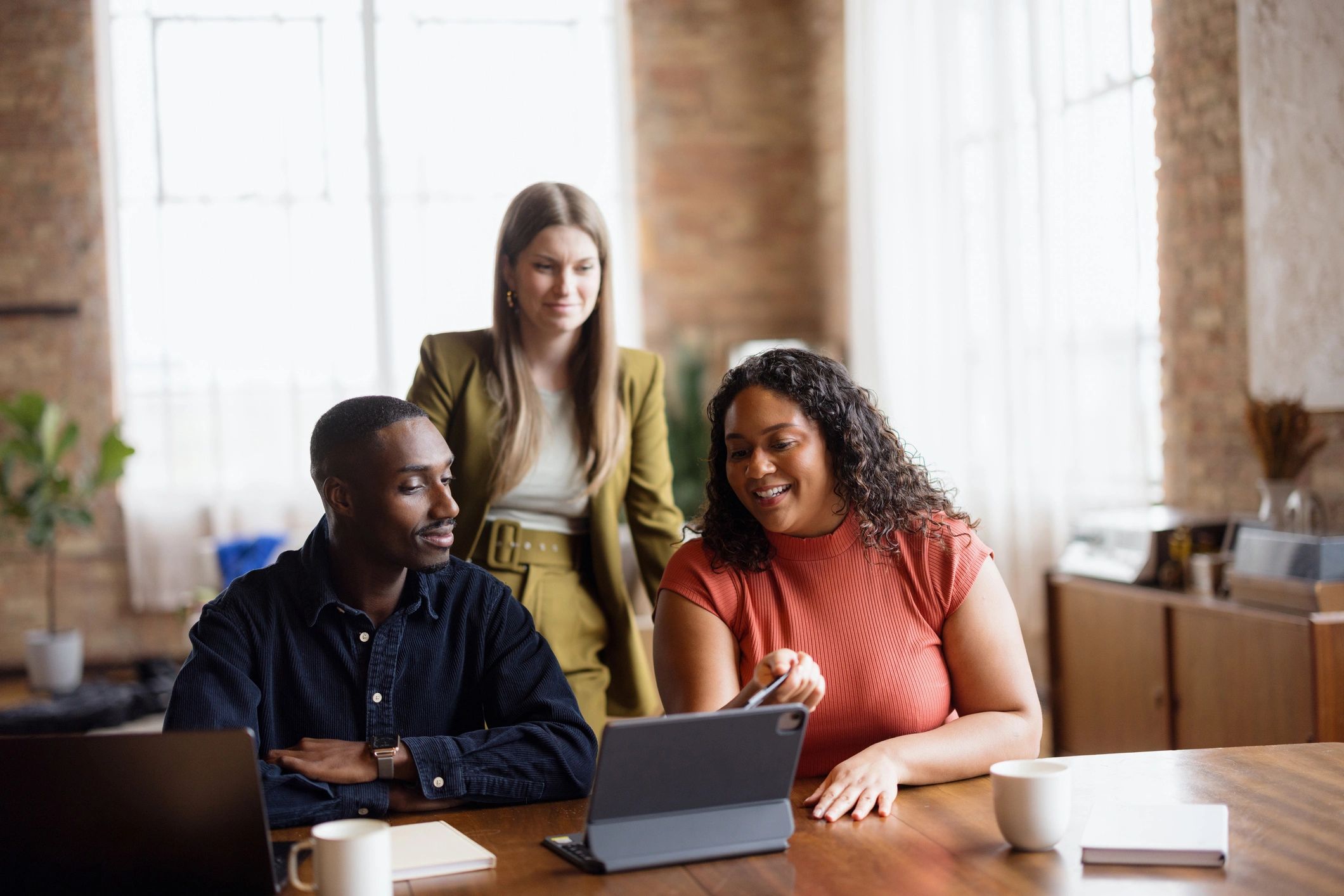 Business team collaborating around a tablet in an office