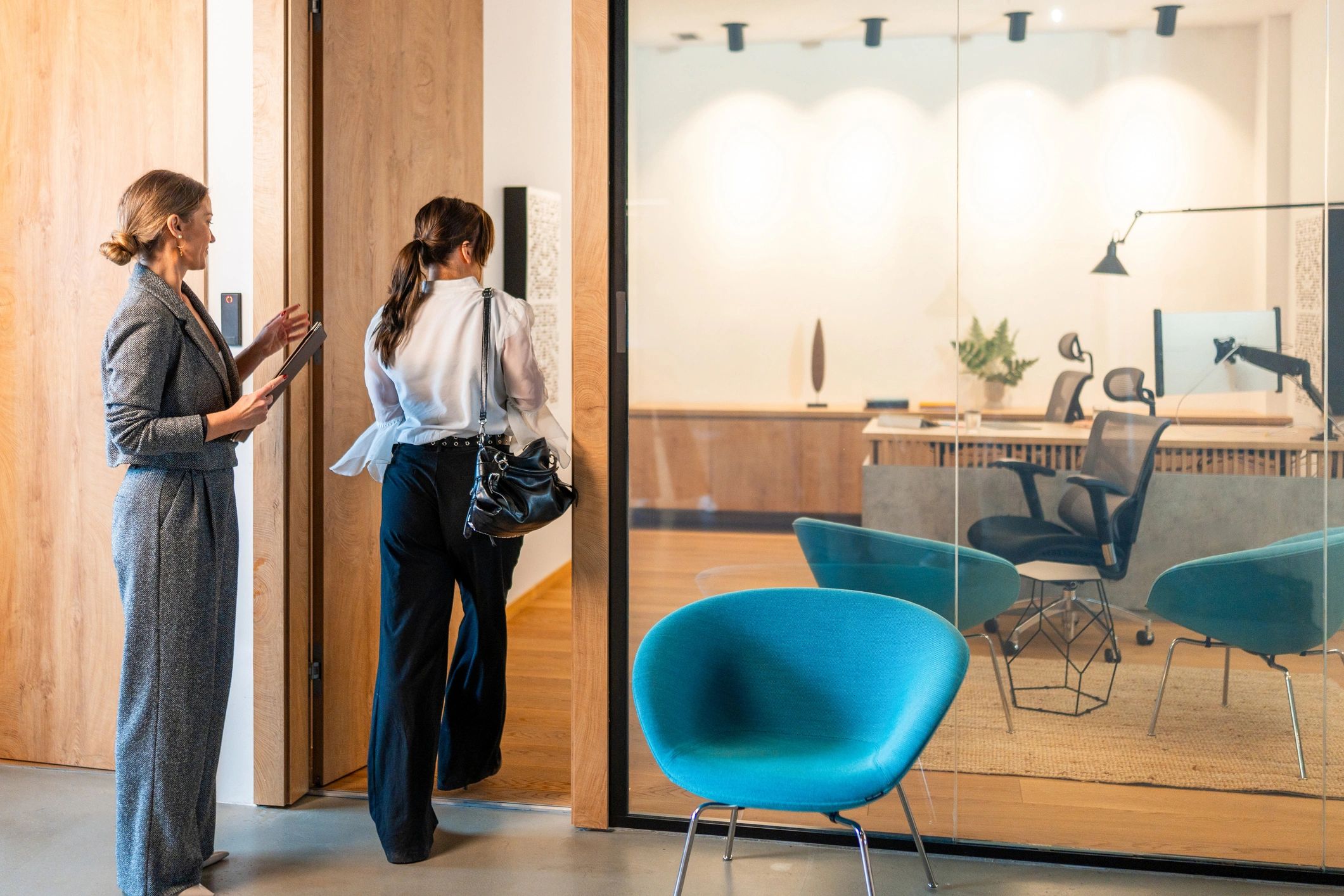Candidate being guided into a modern office meeting room for an interview