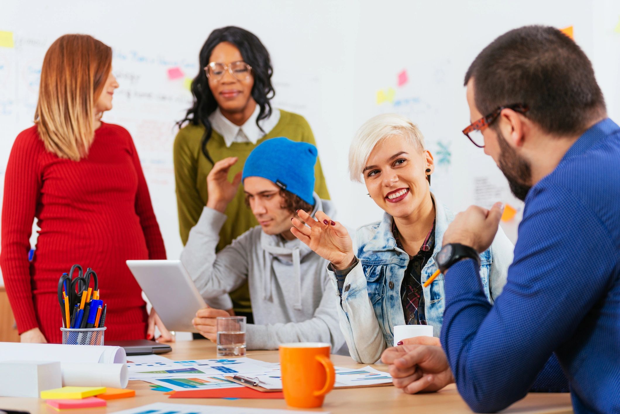 Professionals collaborating during a high-tech office meeting
